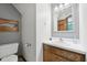 Cozy bathroom features a vanity with a sink, toilet, and a decorative wooden wall hanging at 300 Hutchins Dr, Garner, NC 27529