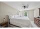 Bright bedroom featuring a ceiling fan, large bed, and natural light from two windows at 300 Hutchins Dr, Garner, NC 27529