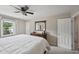 Bright Primary bedroom featuring a ceiling fan, window, dresser, and natural light at 300 Hutchins Dr, Garner, NC 27529