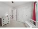 A bedroom with a wooden dresser, a cushioned bench, and an entrance to the hallway of the home at 300 Hutchins Dr, Garner, NC 27529