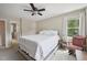 Neutral Primary bedroom featuring a ceiling fan, window, and decor details at 300 Hutchins Dr, Garner, NC 27529