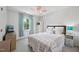 Bright bedroom with a cozy bed, and a window providing ample natural light with light-blue curtains at 300 Hutchins Dr, Garner, NC 27529
