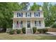 Charming two-story home with a welcoming front porch and neatly landscaped yard at 300 Hutchins Dr, Garner, NC 27529