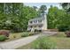 Beautiful two-story home featuring a front porch and a long, paved driveway at 300 Hutchins Dr, Garner, NC 27529