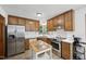 Kitchen with stainless steel appliances, kitchen island, and wood cabinets at 300 Hutchins Dr, Garner, NC 27529
