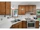 Well-lit kitchen with stainless steel appliances and wood cabinetry at 300 Hutchins Dr, Garner, NC 27529
