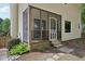Charming screened-in porch of a yellow home with beautiful garden and stone pathway at 300 Hutchins Dr, Garner, NC 27529