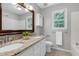 Bathroom with granite countertop, double sinks, large mirror, and tile floor, plus bright natural light at 300 Silvercliff Trl, Cary, NC 27513