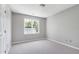 Bright carpeted bedroom with neutral paint and a window, providing a simple and inviting space at 300 Silvercliff Trl, Cary, NC 27513