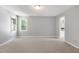 Bright, carpeted bedroom featuring two windows and neutral paint for a versatile, welcoming space at 300 Silvercliff Trl, Cary, NC 27513