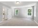 Carpeted bedroom with natural light from three windows, offering a comfortable and bright space at 300 Silvercliff Trl, Cary, NC 27513