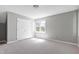 Bright, carpeted bedroom with double closet and natural light from the window providing a relaxing space at 300 Silvercliff Trl, Cary, NC 27513