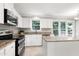 This spacious kitchen has white cabinets, stainless steel appliances, granite counters, and a kitchen island at 300 Silvercliff Trl, Cary, NC 27513