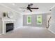 Inviting living room with a fireplace, ceiling fan, neutral paint, and large windows at 300 Silvercliff Trl, Cary, NC 27513