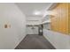 Unfinished basement space with a water heater, pegboard wall, and simple shelving at 300 Wakewood Ct, Raleigh, NC 27615