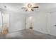 A bright bedroom with a ceiling fan and doors leading to the ensuite bathroom at 300 Wakewood Ct, Raleigh, NC 27615