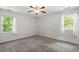 Spacious bedroom with carpeted floors, natural light, and a ceiling fan at 300 Wakewood Ct, Raleigh, NC 27615