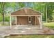 Attached carport featuring support pillars, offering convenient parking space at 300 Wakewood Ct, Raleigh, NC 27615