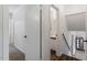 Hallway with white walls, modern lighting and access to the bathroom and stairs at 300 Wakewood Ct, Raleigh, NC 27615