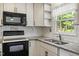 Modern kitchen with white cabinets, subway tile backsplash, and stainless appliances at 300 Wakewood Ct, Raleigh, NC 27615