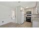Well-appointed kitchen with white cabinets, granite counters, and modern appliances at 300 Wakewood Ct, Raleigh, NC 27615