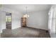Spacious living room with hardwood floors, a decorative chandelier, and ample natural light at 300 Wakewood Ct, Raleigh, NC 27615