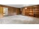 Spacious living room featuring paneled walls, built-in bookshelves, and a vintage lighting fixture at 300 Wakewood Ct, Raleigh, NC 27615