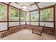 Cozy sunroom with a hanging swing and brick accents, perfect for relaxing indoors at 300 Wakewood Ct, Raleigh, NC 27615