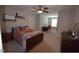 Bedroom featuring neutral carpet, queen-size bed, ceiling fan and windows for plenty of natural light at 3032 Curling Creek Dr, Apex, NC 27502