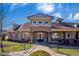 The community clubhouse with a stone entrance, sidewalk, and beautifully landscaped grounds at 3032 Curling Creek Dr, Apex, NC 27502