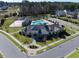 Corner view of a community center with a pool, basketball court, and beautifully landscaped grounds at 3032 Curling Creek Dr, Apex, NC 27502