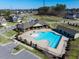 Aerial view of a community pool with a clubhouse, basketball court, and well-maintained landscaping at 3032 Curling Creek Dr, Apex, NC 27502