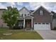 Charming two-story home featuring a brick and siding exterior and a well-maintained front yard at 3032 Curling Creek Dr, Apex, NC 27502