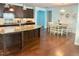 Kitchen featuring granite countertops, dark cabinetry, and a dining table with chairs at 3032 Curling Creek Dr, Apex, NC 27502