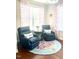 Cozy sitting area with comfortable chairs, a round table, and a patterned area rug at 3032 Curling Creek Dr, Apex, NC 27502