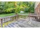 Enjoy the view from this backyard deck with a wood railing overlooking the lush backyard at 3209 Marie Dr, Raleigh, NC 27604