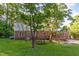 Large, grassy backyard features a picnic table and lovely mature shade trees at 3209 Marie Dr, Raleigh, NC 27604
