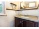 Bathroom featuring a wooden vanity with granite countertop and framed mirror at 3209 Marie Dr, Raleigh, NC 27604