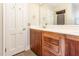 Bathroom vanity features wooden cabinetry with a light countertop and views of the shower at 3209 Marie Dr, Raleigh, NC 27604