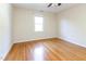 Empty bedroom featuring hardwood floors and a large window at 3209 Marie Dr, Raleigh, NC 27604
