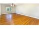 Bedroom with hardwood floors, neutral walls, and a large window at 3209 Marie Dr, Raleigh, NC 27604