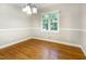 Dining room with hardwood floors, chair rail, and a window with natural light at 3209 Marie Dr, Raleigh, NC 27604