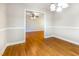 Open dining room entryway featuring hardwood floors flowing into the living room at 3209 Marie Dr, Raleigh, NC 27604
