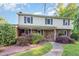 Charming two-story home featuring a brick facade, covered porch, and beautifully landscaped front yard at 3209 Marie Dr, Raleigh, NC 27604