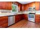 Updated kitchen featuring stainless appliances, granite countertops, and wood cabinetry at 3209 Marie Dr, Raleigh, NC 27604