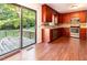 Kitchen featuring wood cabinets, stainless steel appliances, and access to the back deck at 3209 Marie Dr, Raleigh, NC 27604