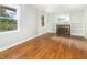 Light-filled living room boasts a cozy fireplace and beautiful hardwood floors at 3209 Marie Dr, Raleigh, NC 27604