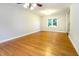 Bright living room featuring hardwood floors, a ceiling fan, and a large window at 3209 Marie Dr, Raleigh, NC 27604
