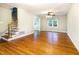 Bright living room with hardwood floors, staircase, and ceiling fan at 3209 Marie Dr, Raleigh, NC 27604