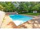 Enjoy a spacious pool area with stone patio, perfect for recreation and outdoor enjoyment at 3209 Marie Dr, Raleigh, NC 27604